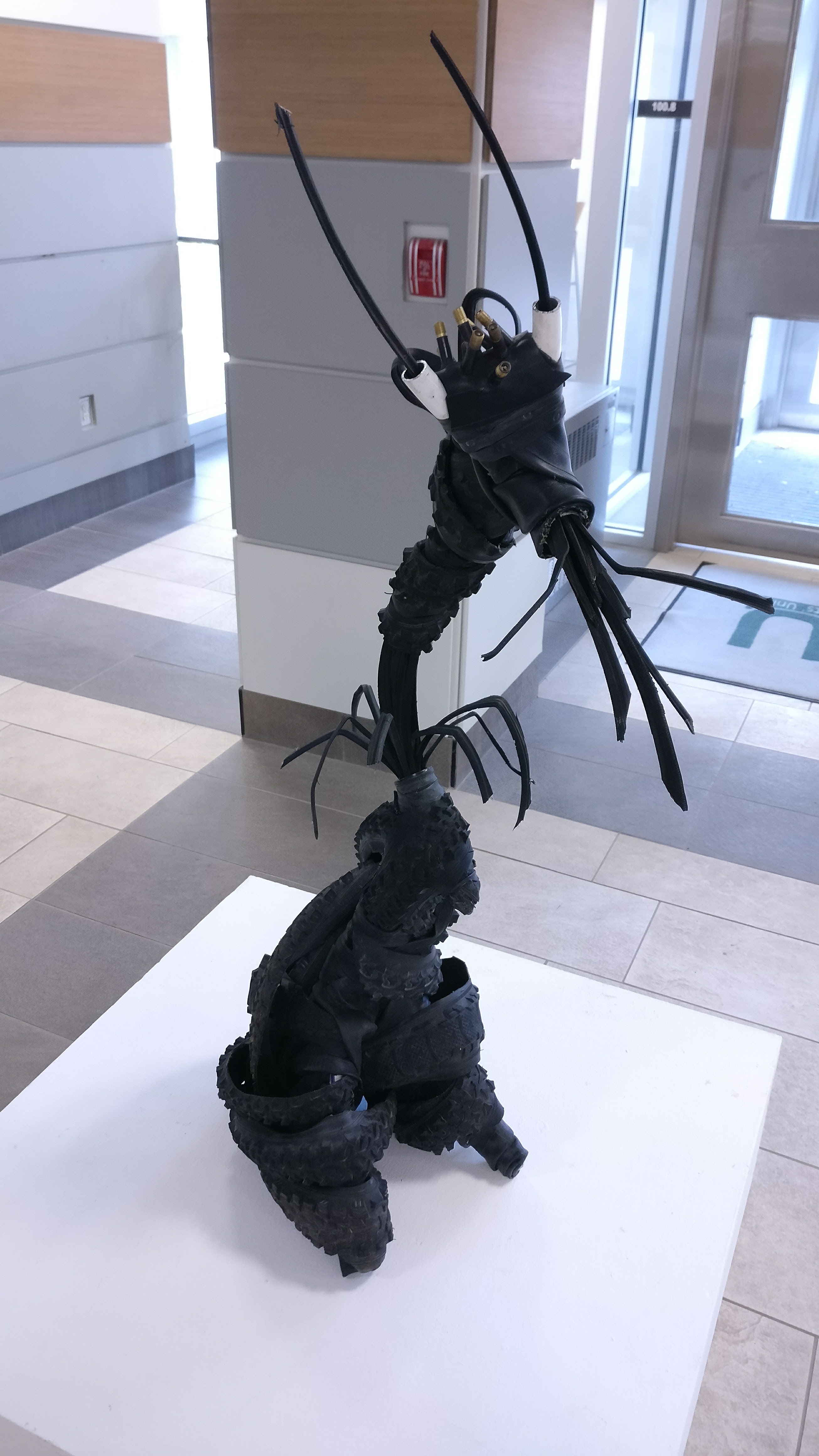 An anthropomorphic creature sculpture made from bike tires and cables by Hailey Jones for ART*Cycled 2017.