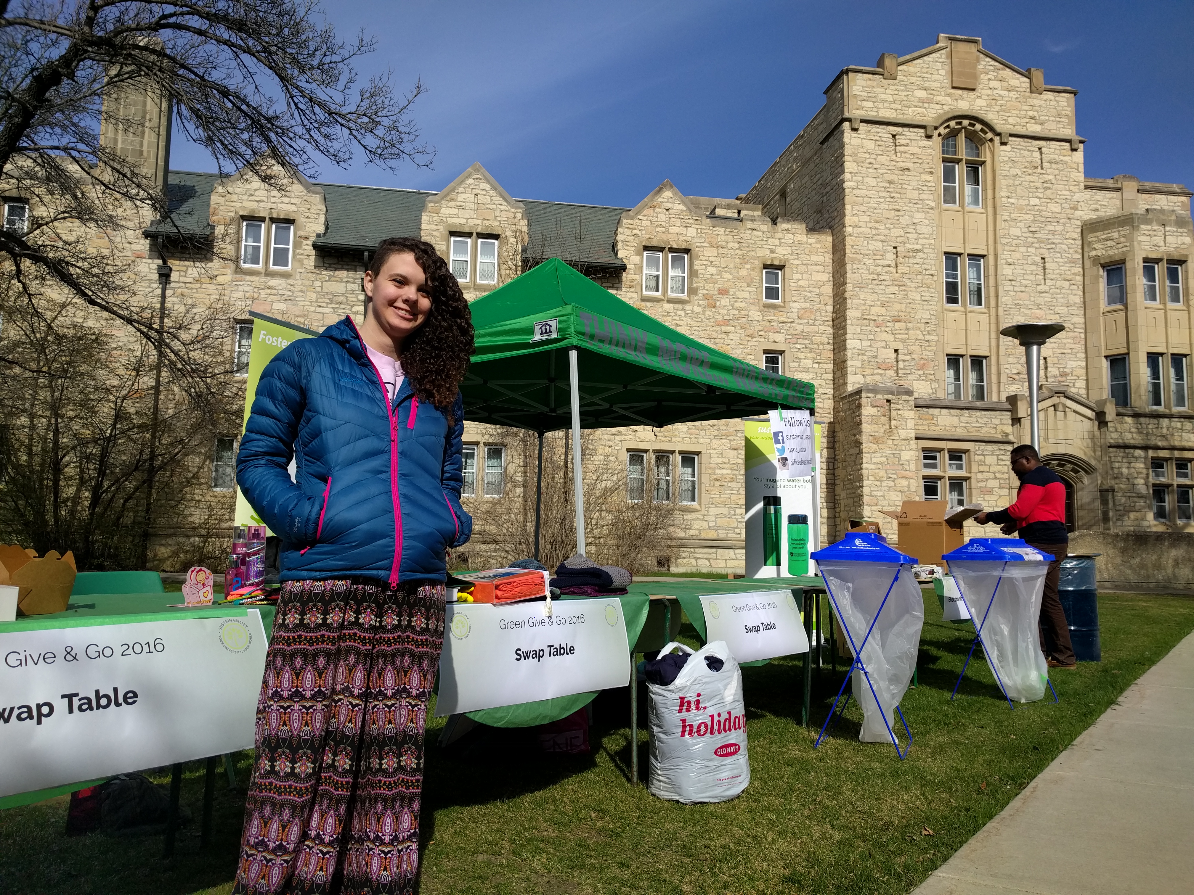 Green Pack volunteer Madeline Berezowski poses with our Green Give and Go swap table on Thursday.