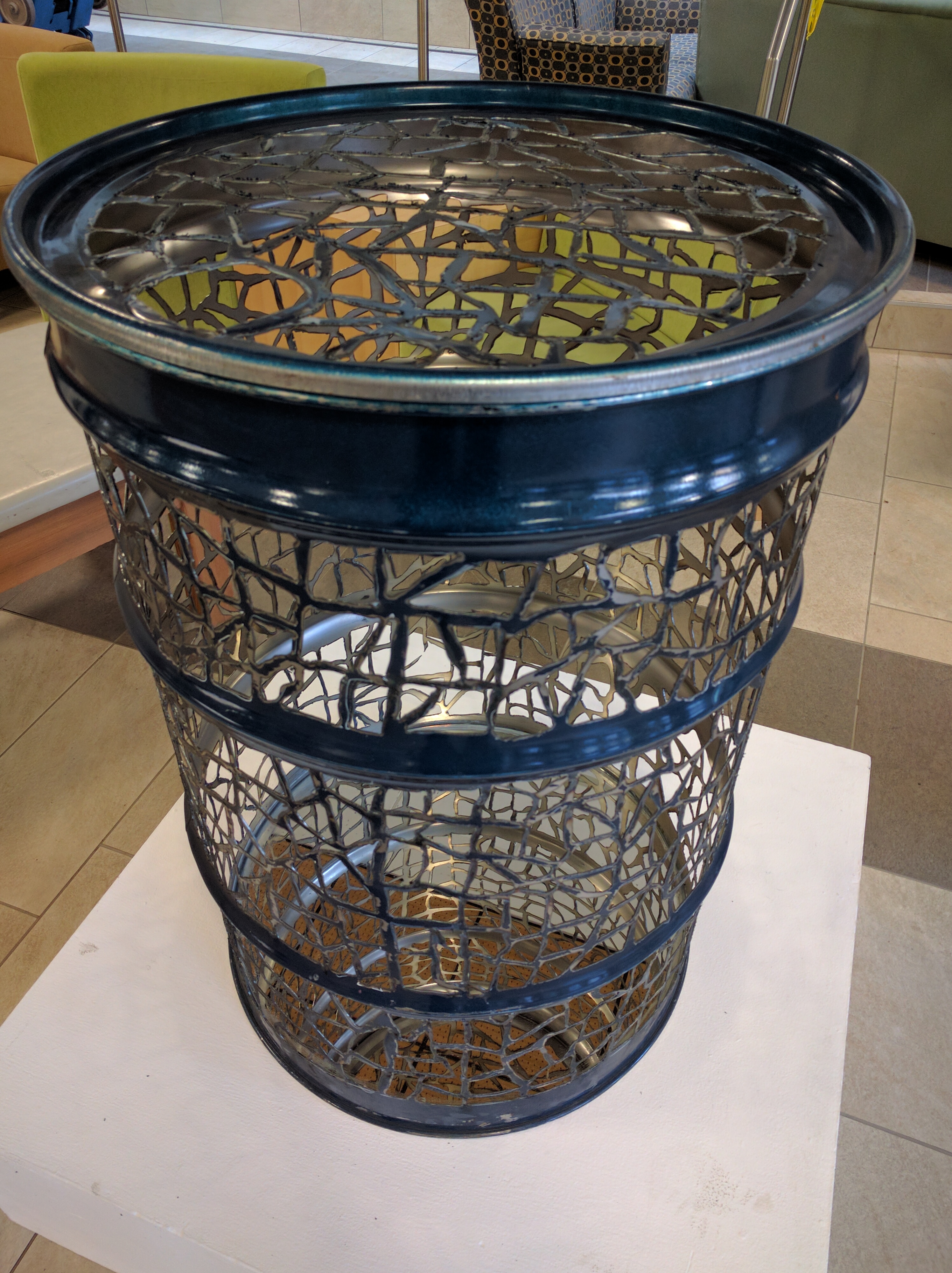 An intricately laser cut waste barrel made by Dani Dale