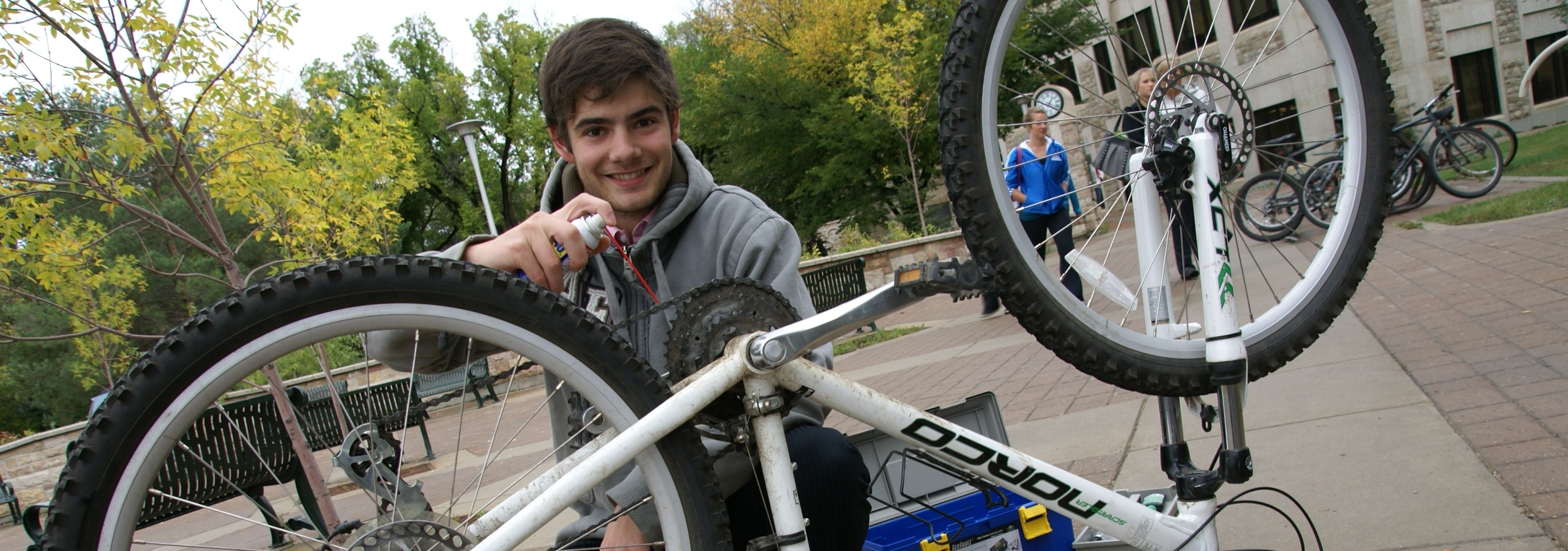 A student conducting a bike tune-up on campus